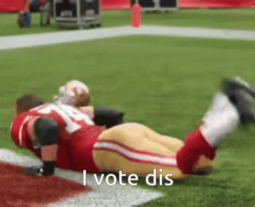 Football Player Laying on Ground Saying I Vote Dis