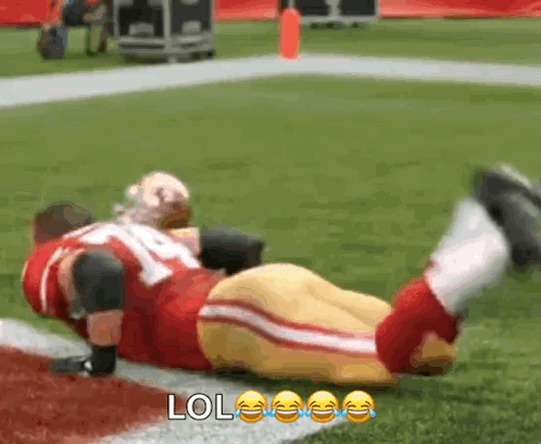 Football Player Lying on Field With LOL Face