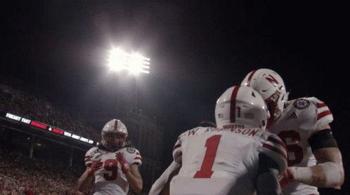 Football Player Number 1 Hugging Another Player