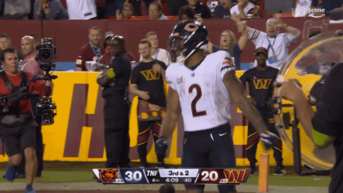 Football Player Number 10 Being Tackled