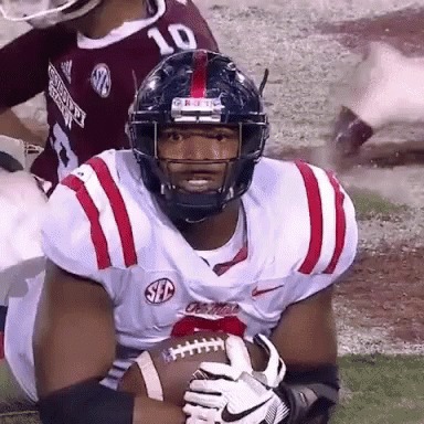 Football Player Number 10 Holding Football