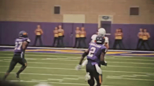 Football Player Number 10 Standing on Field