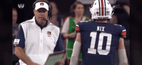 Football Player Number 10 Talking to Coach