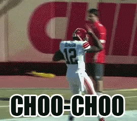 Football Player Number 12 Being Tackled
