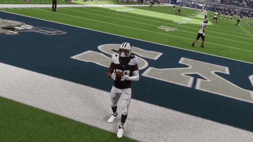 Football Player Number 12 Running on Field