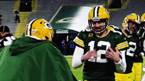 Football Player Number 12 Talking to Another Player