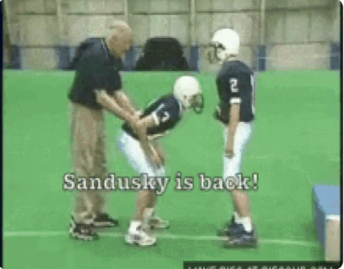 Football Player Number 13 Helped by Coach