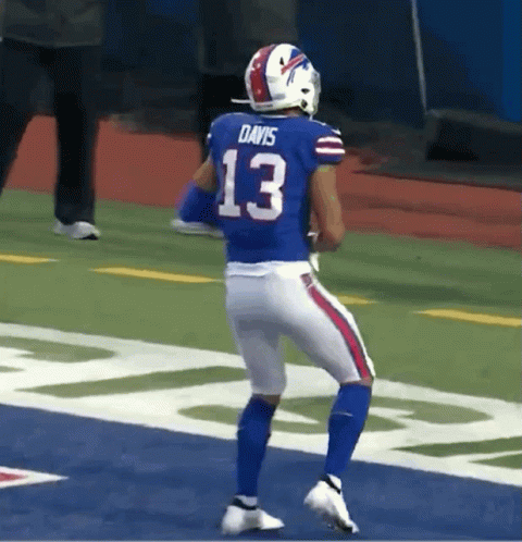 Football Player Number 13 Running on Field