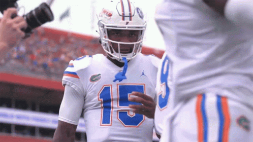 Football Player Number 15 Talks To Another Player GIF
