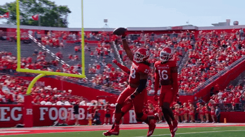 Football Player Number 16 Jumping in Air