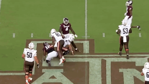 Football Player Number 18 Being Tackled