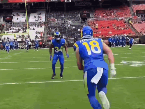 Football Player Number 18 Running With Ball