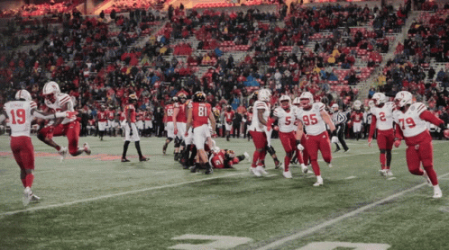 Football Player Number 19 Running on Field