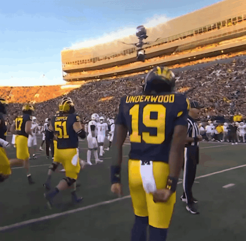 Football Player Number 19 Stands on Field