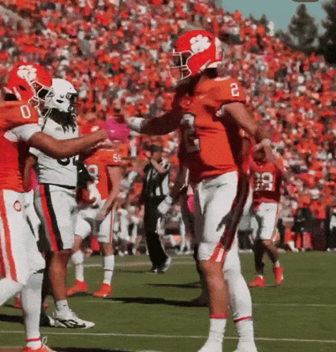 Football Player Number 2 Being Hugged By Another Player GIF