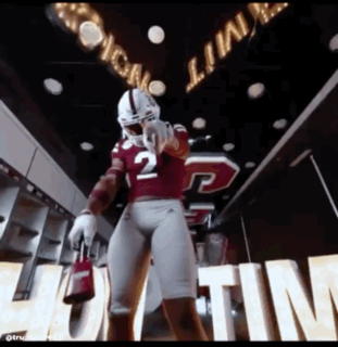 Football Player Number 2 in Locker Room