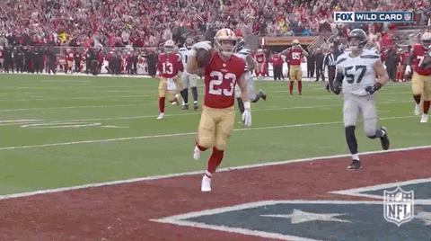 Football Player Number 23 Running With Ball