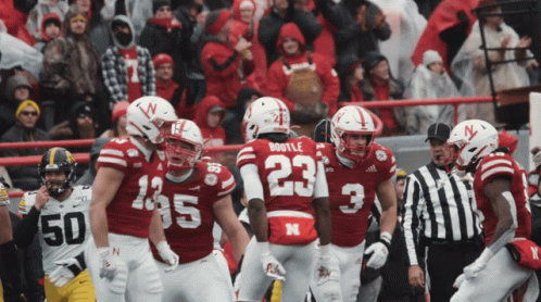 Football Player Number 23 Surrounded by Teammates