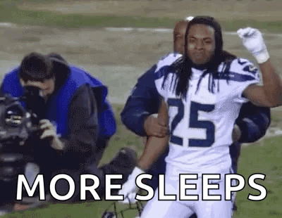 Football Player Number 25 Helped Off Field by Teammate