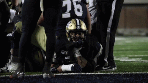Football Player Number 26 Laying on Field