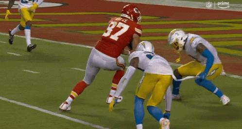 Football Player Number 27 Being Tackled