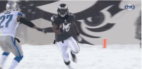 Football Player Number 27 Running With Ball