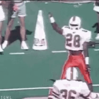 Football Player Number 28 Jumping Over Another Player