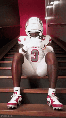 Football Player Number 3 Sitting on Stairs