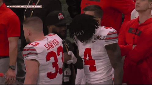 Football Player Number 34 Talking to Another Player