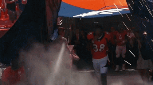 Football Player Number 38 Running Through Tunnel GIF
