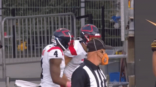 Football Player Number 4 Talking to Another Player