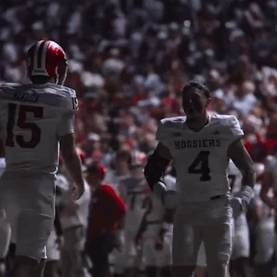 Football Player Number 4 Talking To Another Player GIF