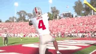 Football Player Number 4 Throwing Ball