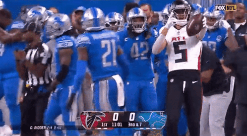 Football Player Number 5 in Front of Group