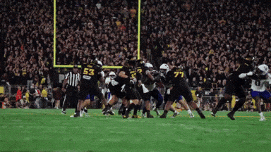 Football Player Number 53 Being Tackled