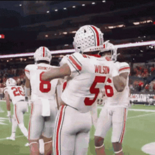 Football Player Number 56 Hugging Teammates