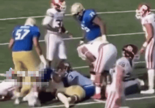 Football Player Number 57 Laying on Field