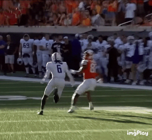 Football Player Number 6 Running Toward Player Number 8