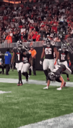 Football Player Number 65 Tackled