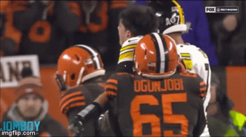 Football Player Number 65 Talking To Another GIF