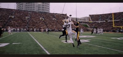 Football Player Number 67 Catching Pass