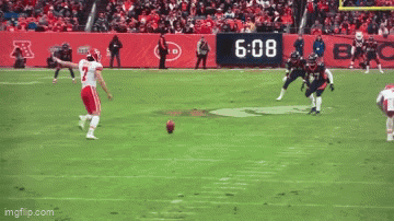 Football Player Number 7 Laying on Ground