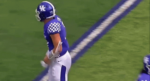 Football Player Number 7 Standing Next To Another GIF