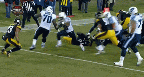 Football Player Number 70 Being Tackled