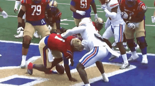 Football Player Number 79 Being Tackled