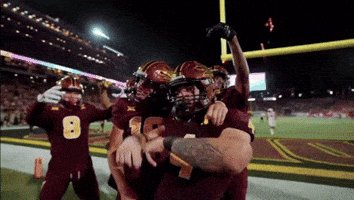 Football Player Number 8 Hugged By Teammates