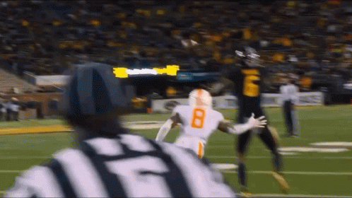 Football Player Number 8 Running Towards Referee