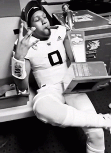 Football Player Number 8 Smoking Cigarette Holding Laptop GIF