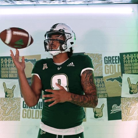 Football Player Number 8 Throws Ball