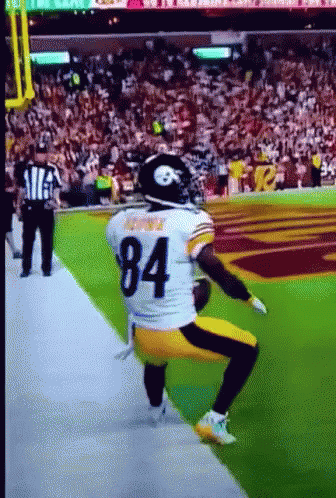 Football Player Number 84 Squatting on Field